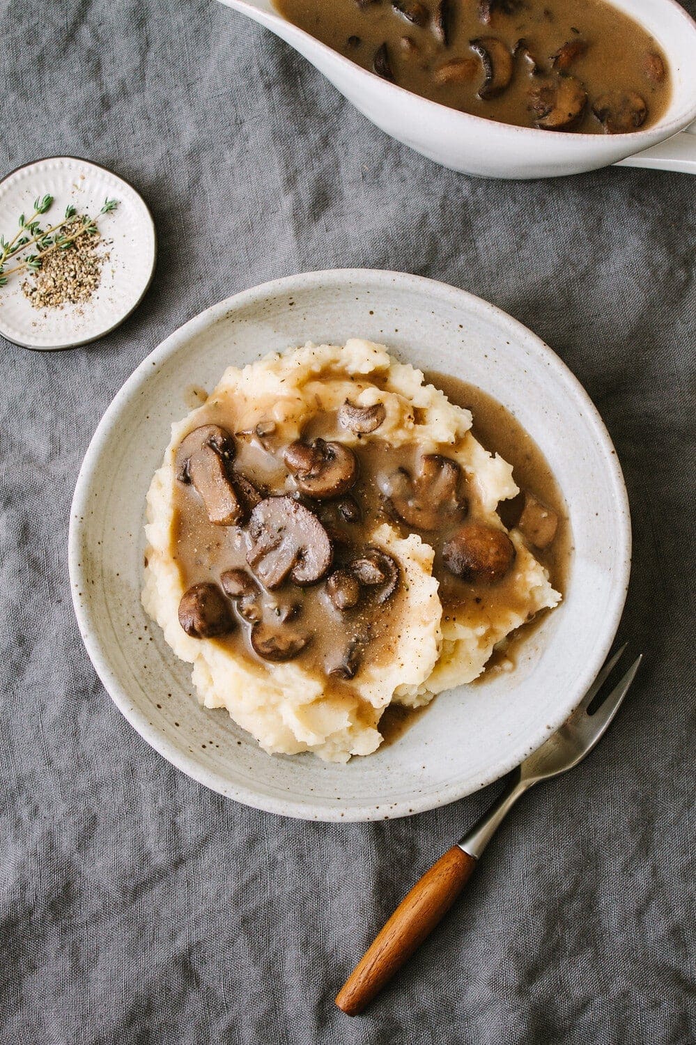 top down view of a bowl of vegan mashed potatoes topped with easy vegan mushroom gravy.