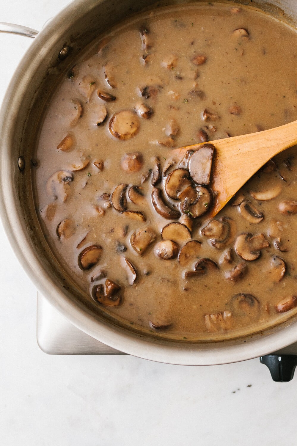 top down view of a shallow pan with freshly made vegan mushroom gravy.