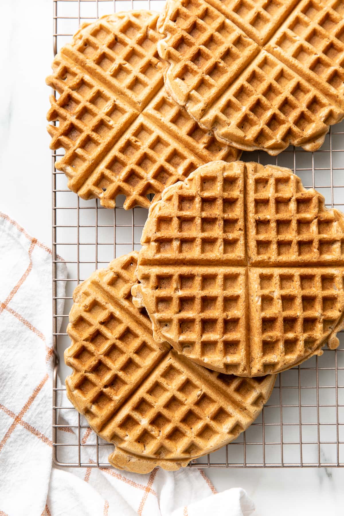 top down view of applesauce waffles on a wire cooling rack