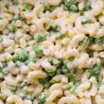 top down, up close view of vegan mac and cheese with peas