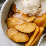 warm spiced cinnamon apples in a bowl with non-dairy vanilla ice cream