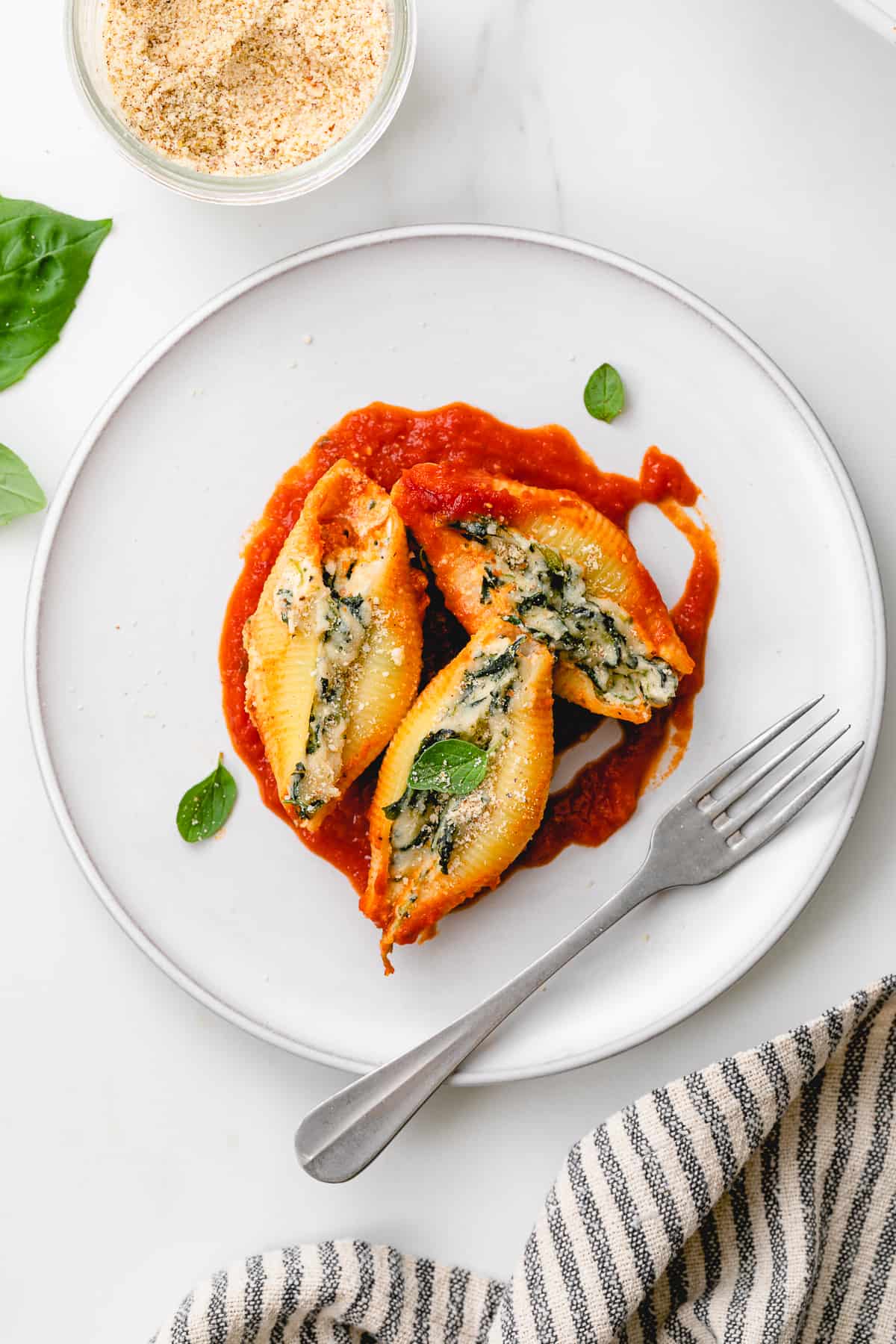 top down view of plated serving of spinach and ricotta vegan stuffed shells.