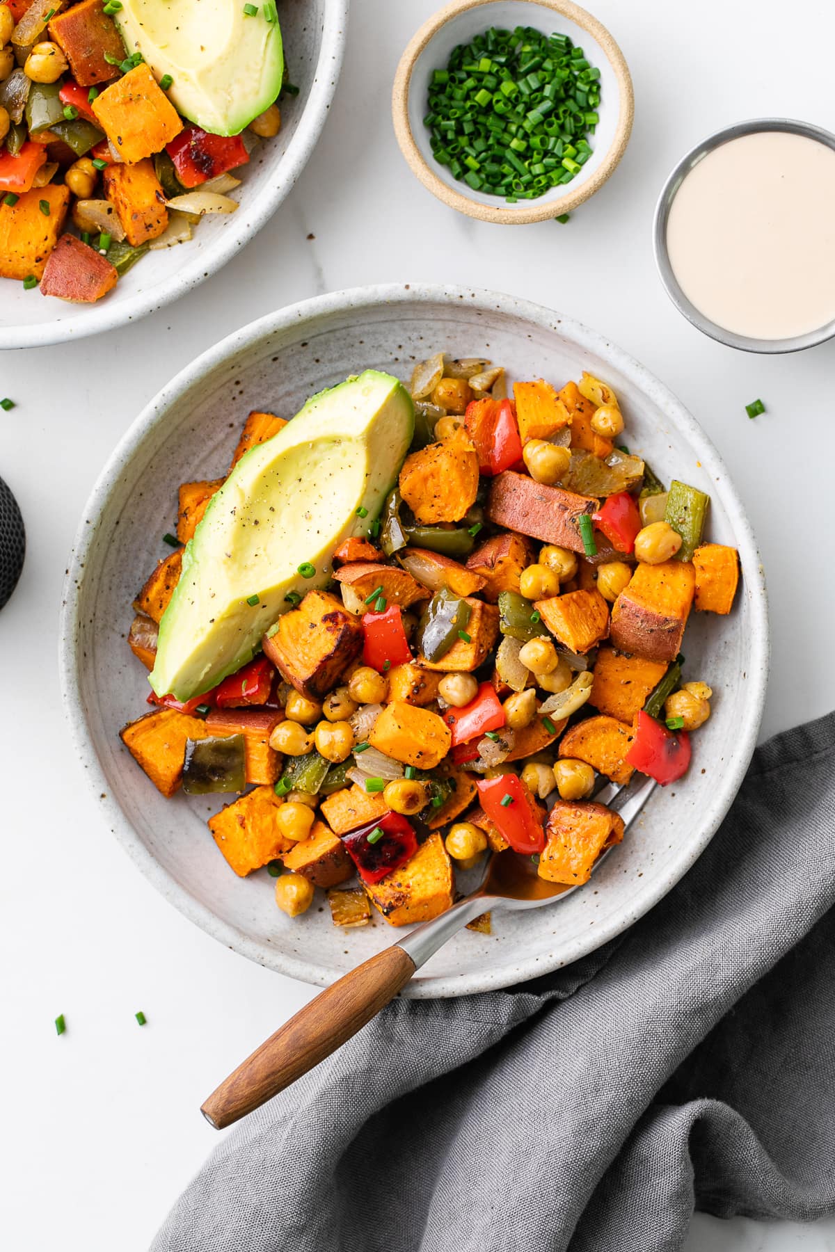 top down view of plated sweet potato breakfast hash with items surrounding.