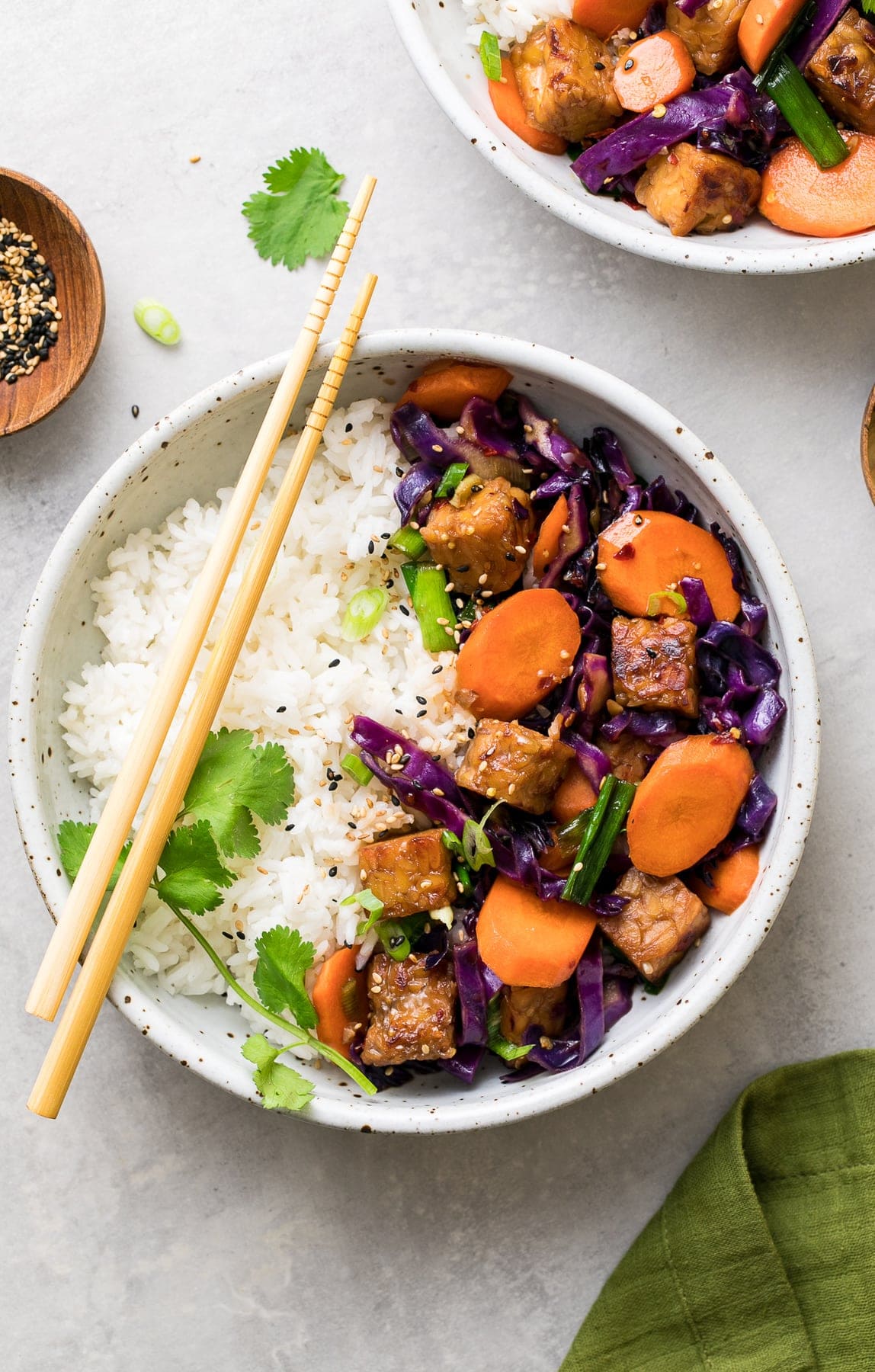 top down view of mirin maple tempeh stir fry in a bowl with rice.