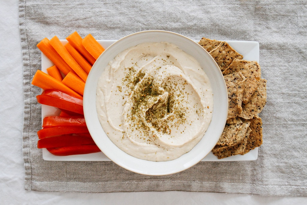 top down view of homemade white bean hummus in a bowl.
