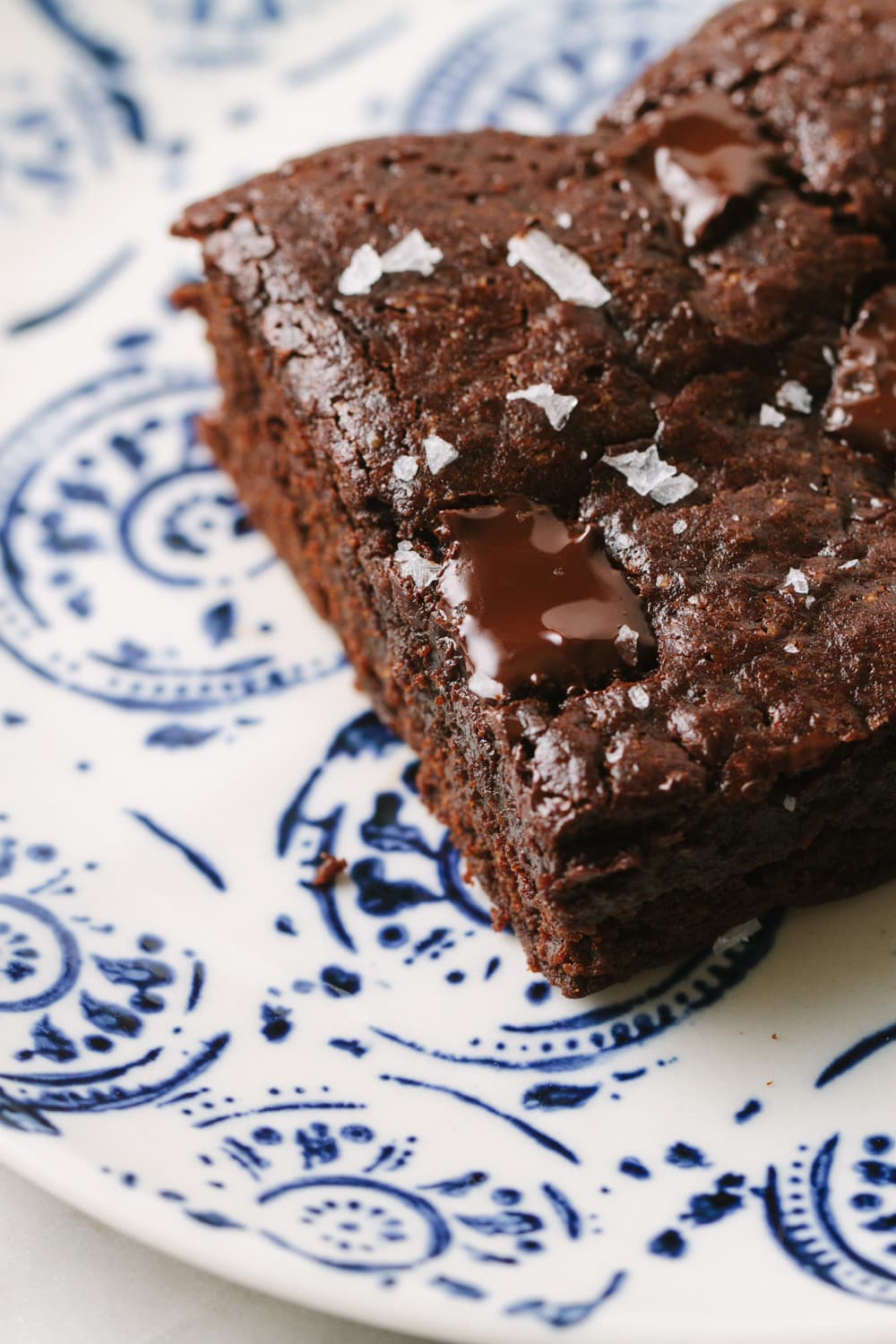 fudgy vegan brownie on a blue and white plate