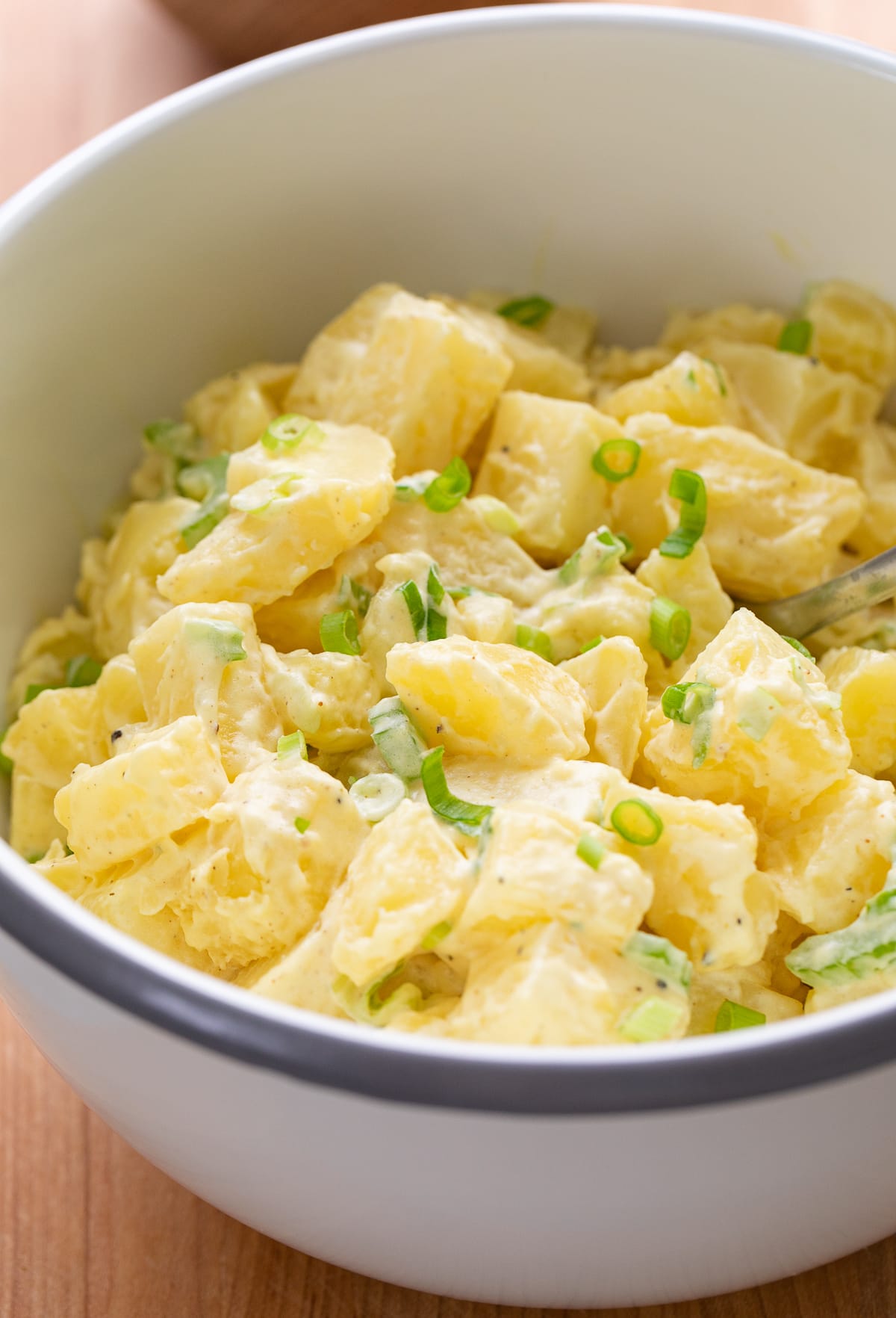 side angle view of bowl with vegan potato salad.