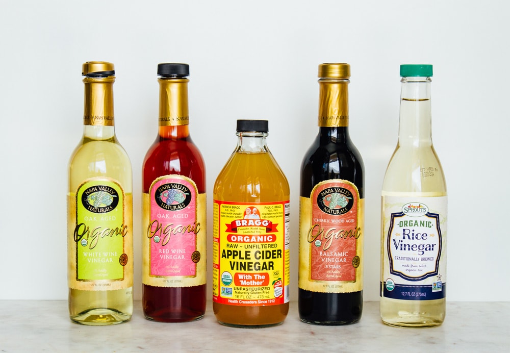 an assortment of organic vinegars for a vegan pantry.