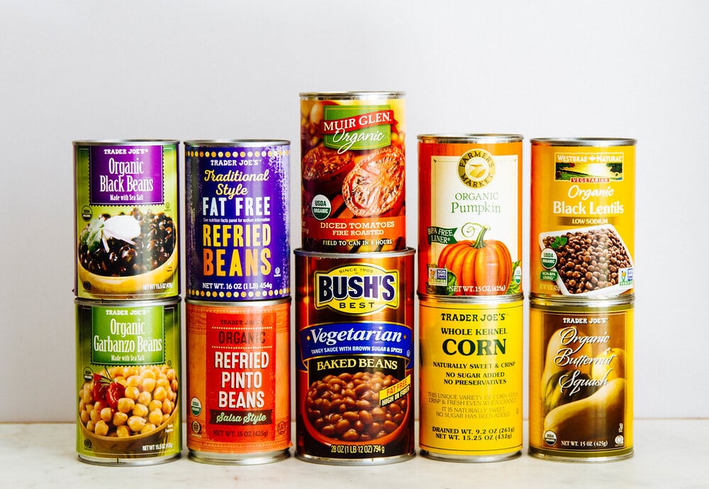 an assortment of canned goods to keep stocked for a healthy vegan pantry.