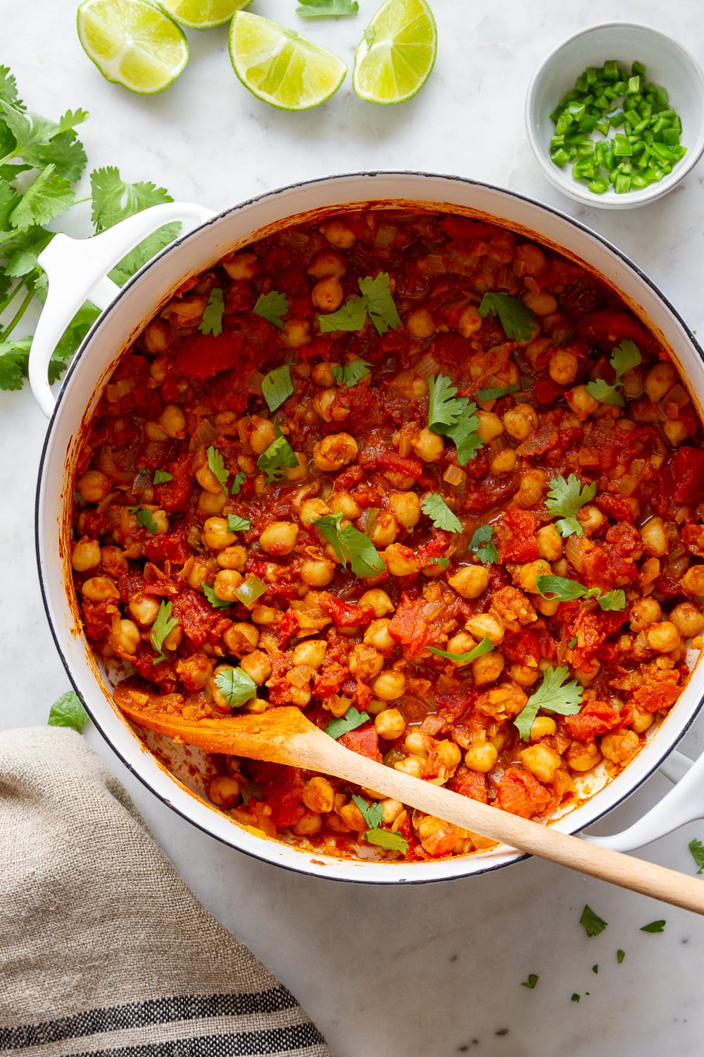 top down view of freshly made chana masala recipe in a white pot.