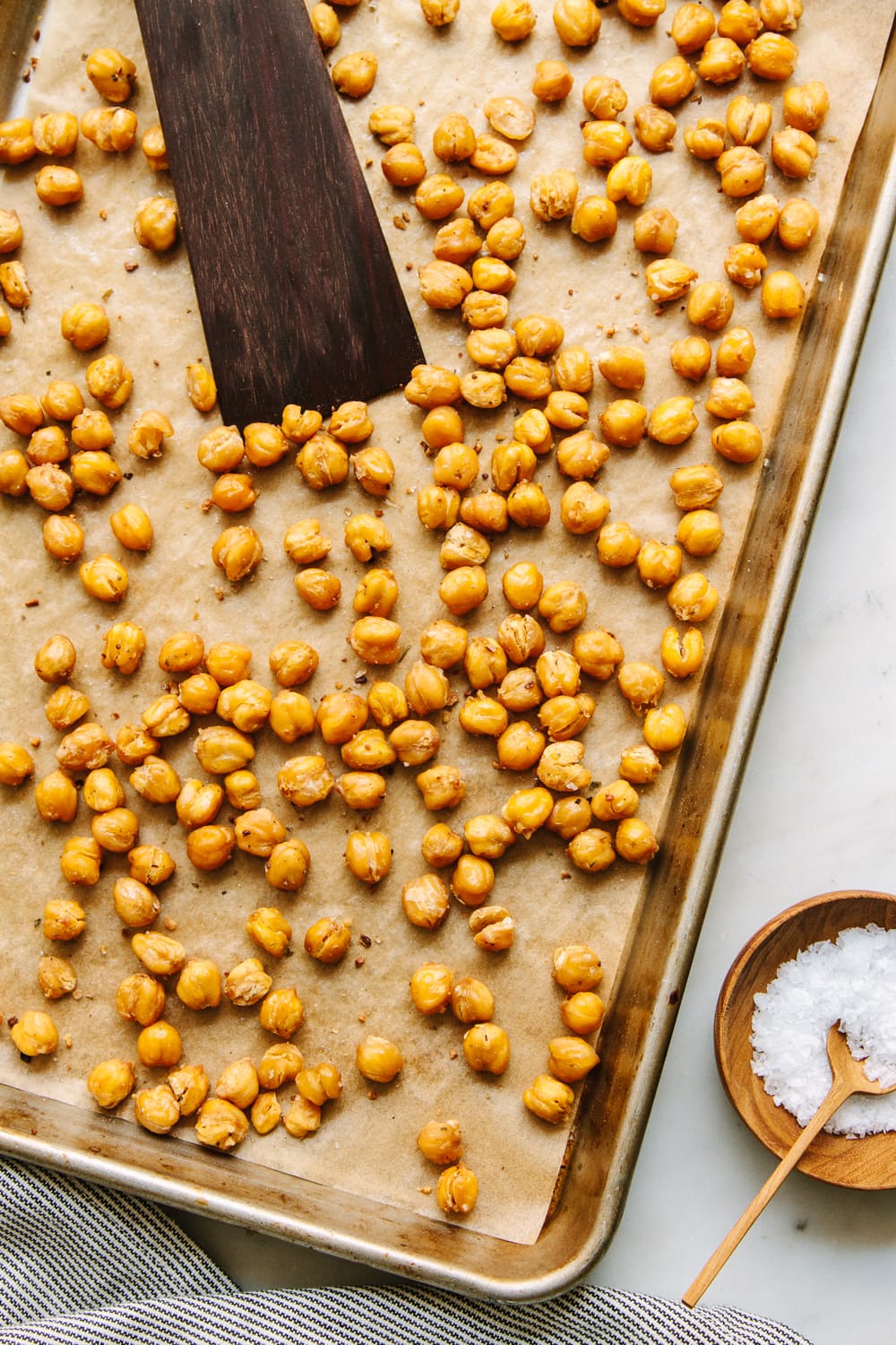 top down view of a rimmed baking sheet with perfectly crispy roasted chickpeas.