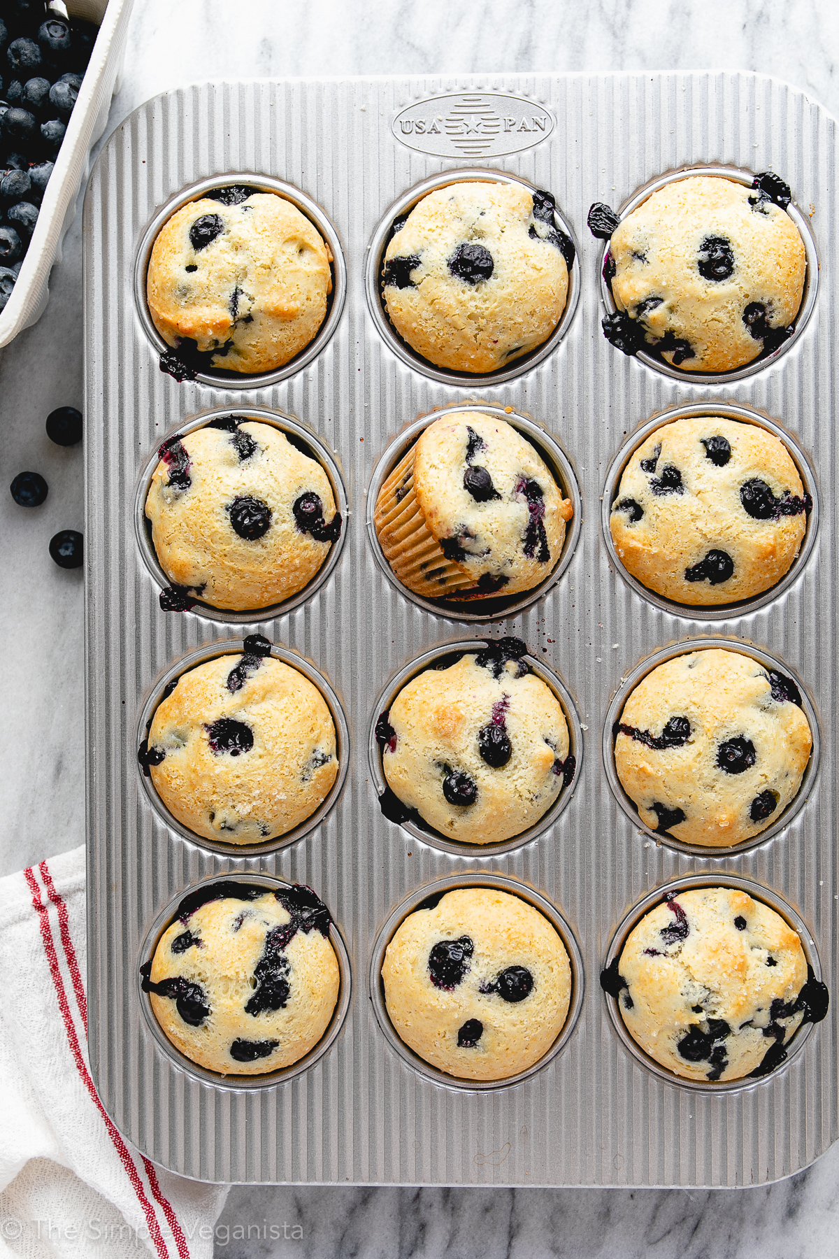 top down view of muffin tin with fresh baked blueberry muffins.