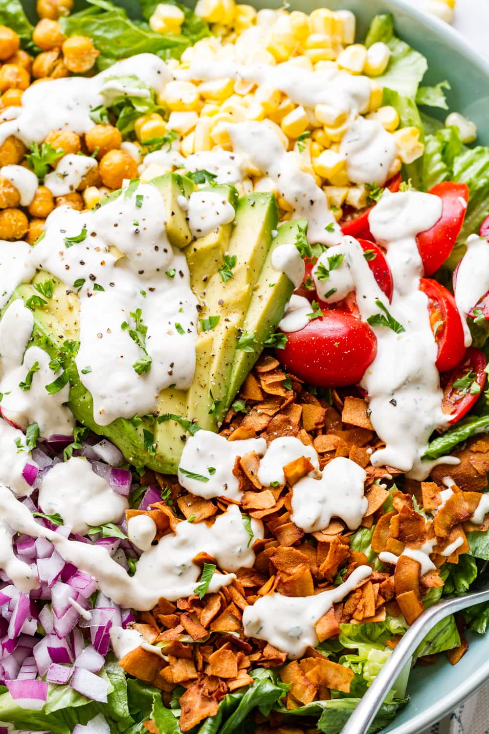 up close side angle view of vegan cobb salad with vegan ranch dressing.