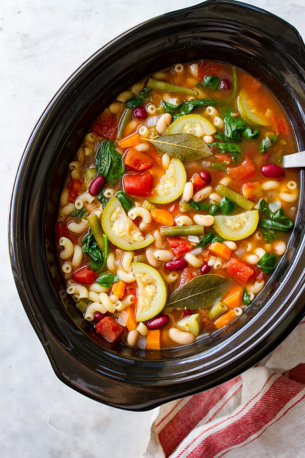 top down view of slow cooker filled with freshly cooked easy minestrone soup.