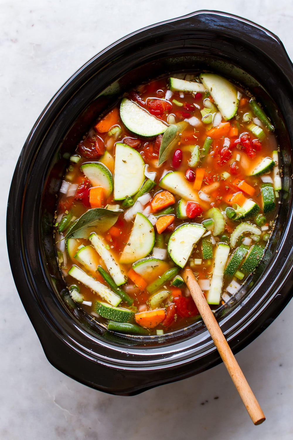 top down view of slow cooker minestrone soup ingredients added to a crockpot and ready to cook.