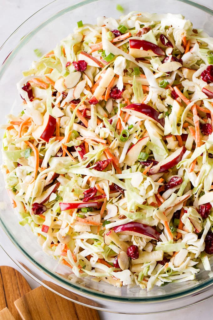 top down view of freshly mixed easy apple coleslaw in a glass bowl.