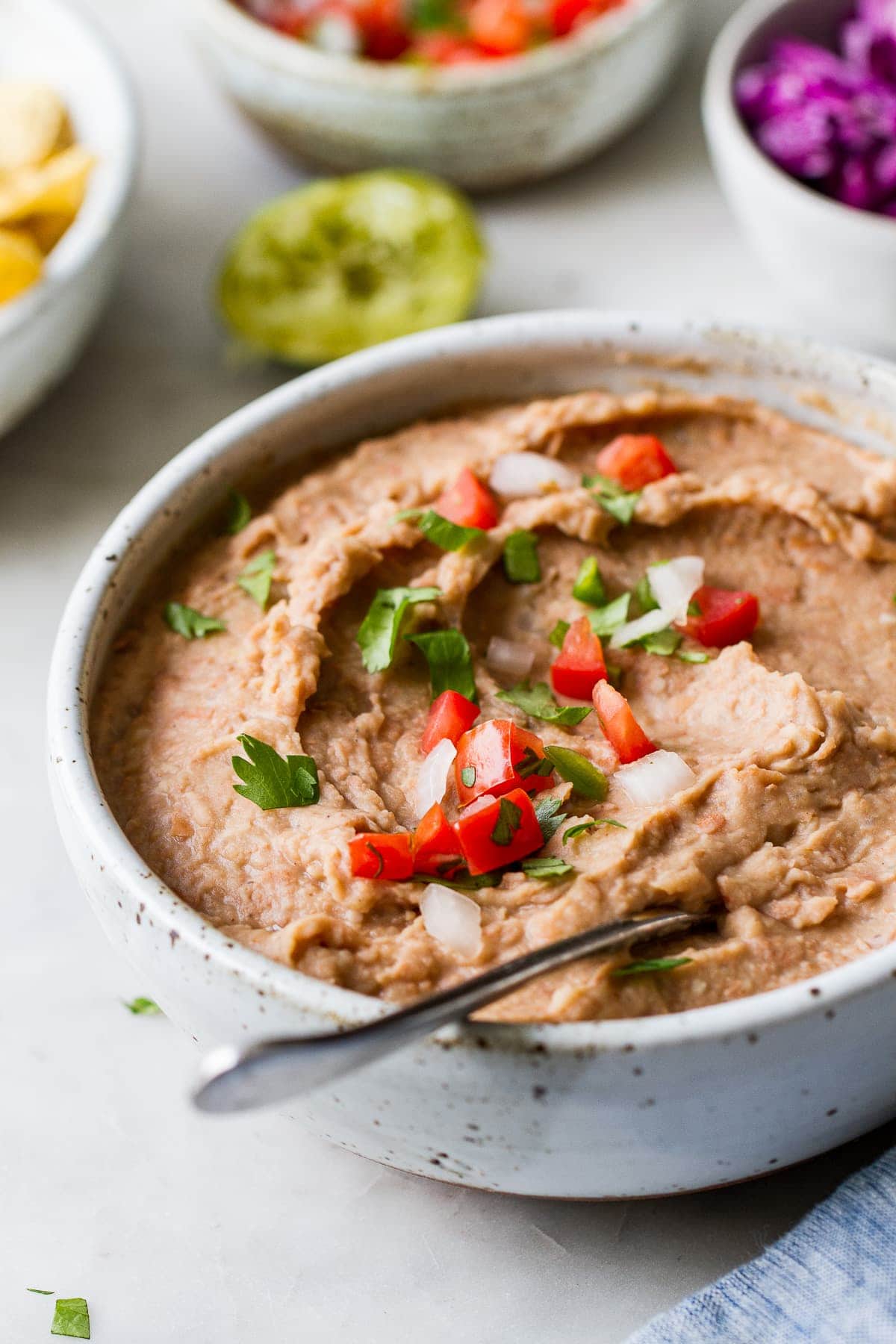 side angle view of quick and easy vegan refried beans in a bowl.