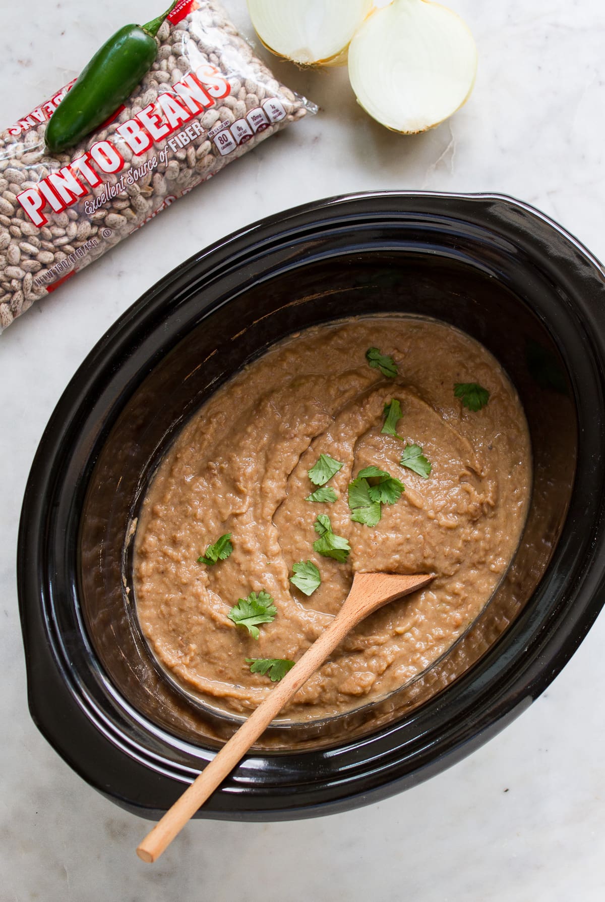 top down view of vegan refried beans made in a slow cooker.