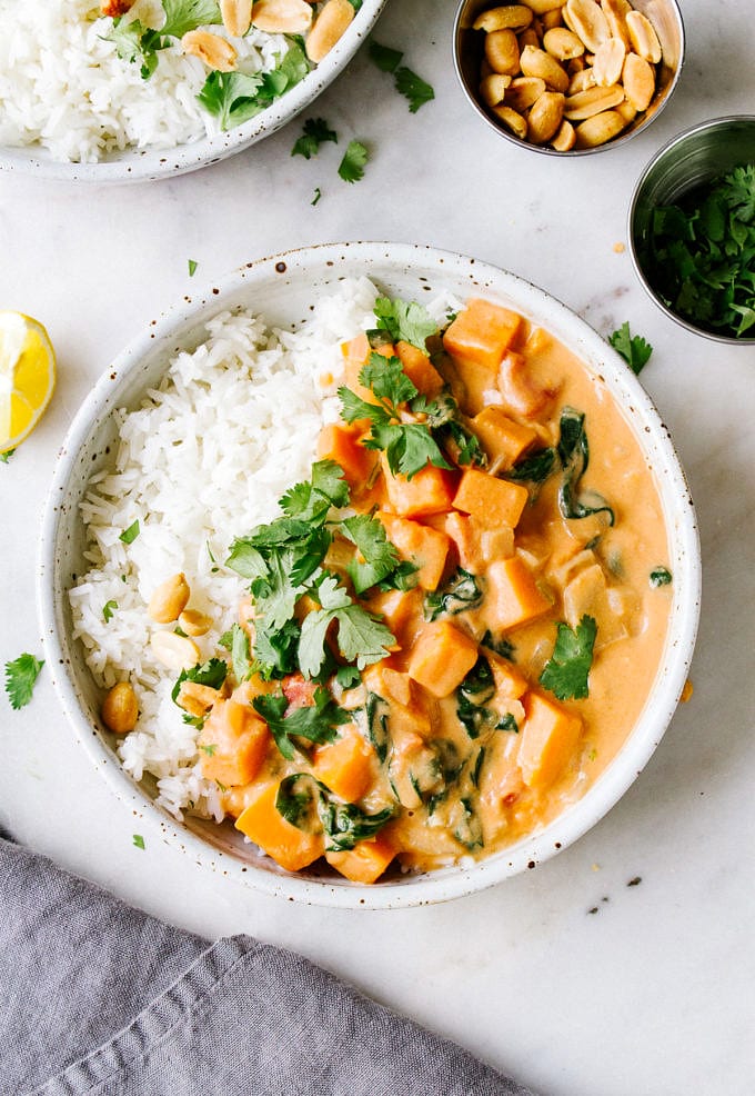 top down view of a bowl with serving of rice and vegan African peanut stew.