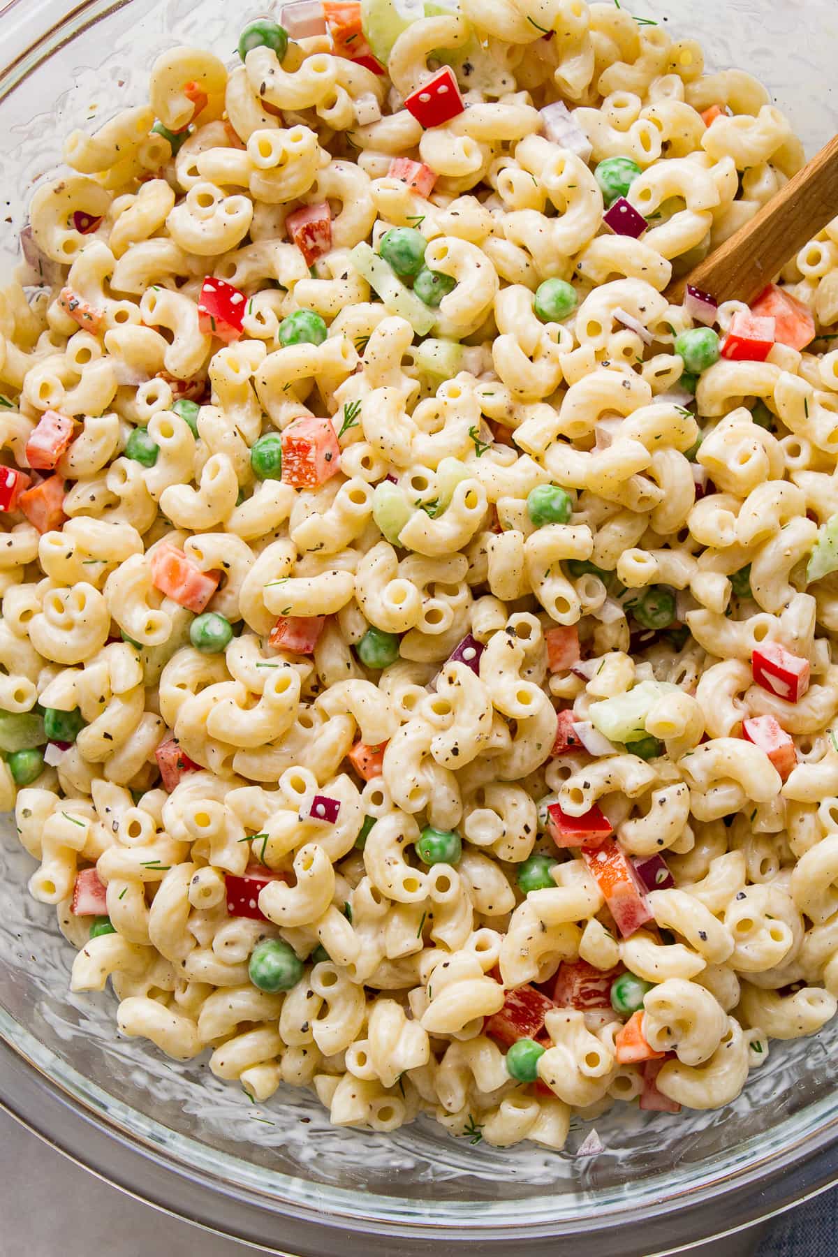 top down view of easy vegan macaroni salad in a glass bowl.