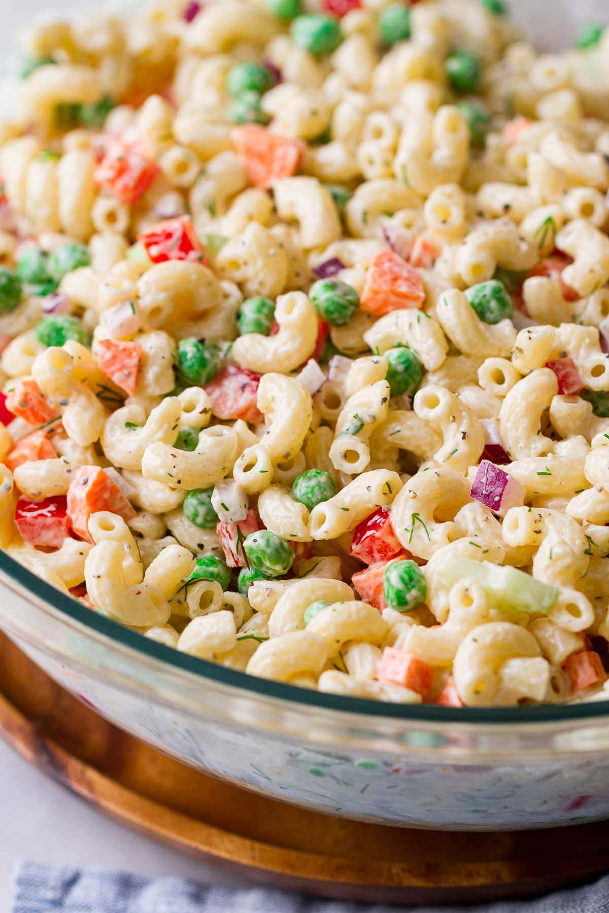 side angle view of vegan macaroni salad in a glass bowl.