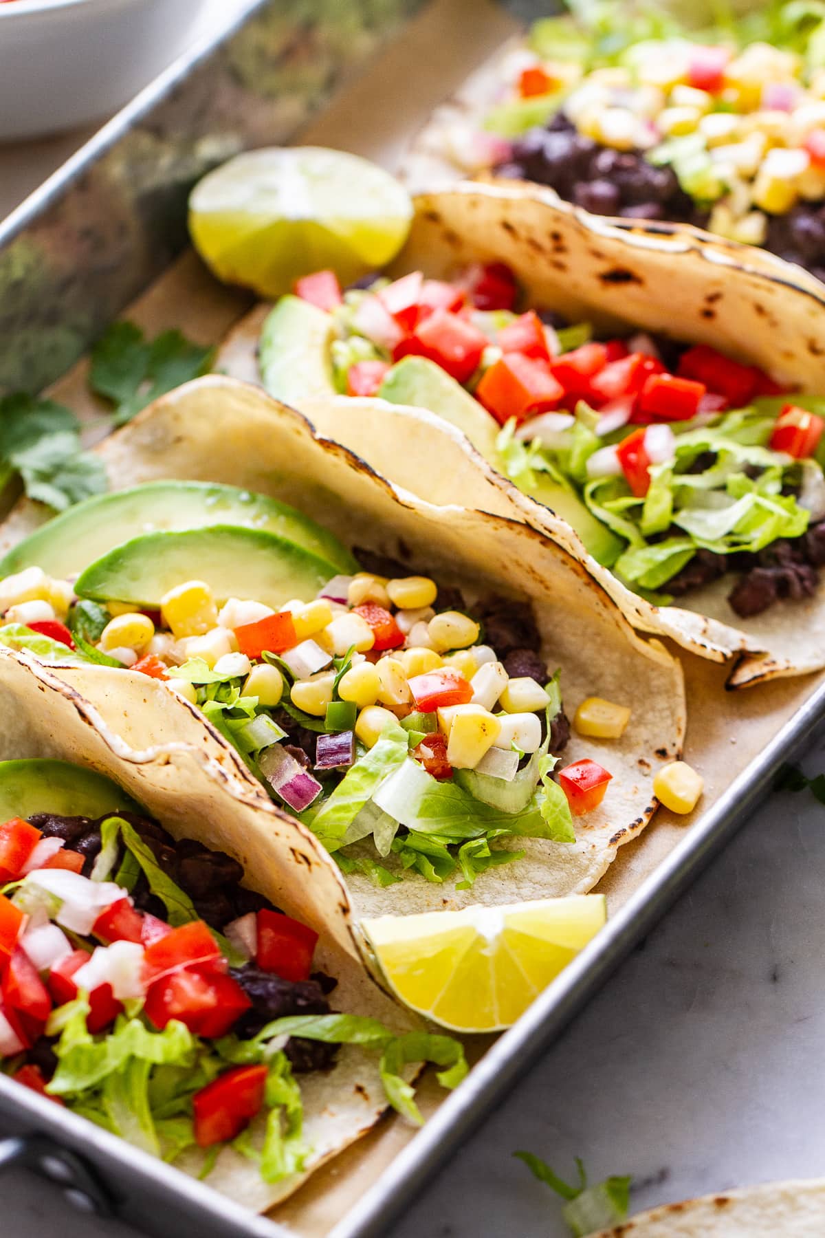 side angle view of easy black bean tacos on a serving tray.