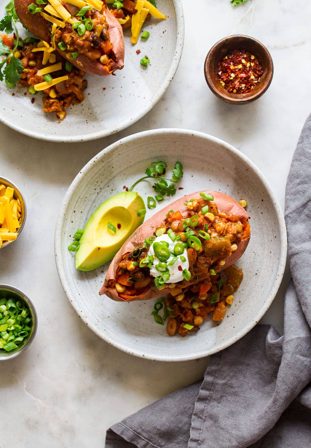 top down view of chili stuffed sweet potato in a shallow serving bowl.