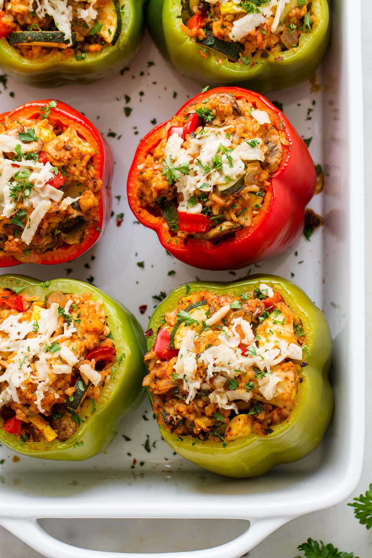 top down view of vegan stuffed bell peppers freshly baked in a baking dish.