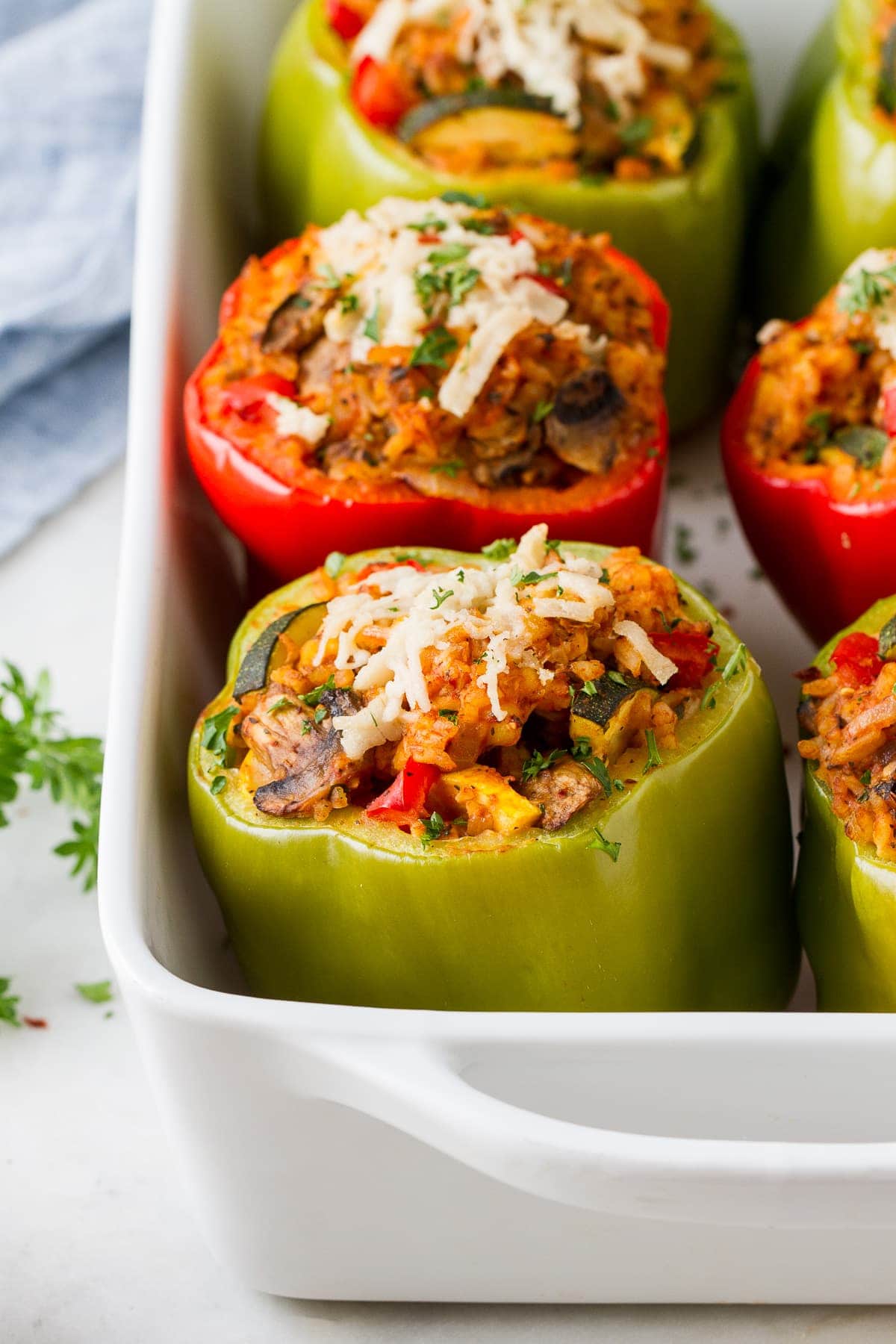 side angle view of vegan stuffed peppers in a baking dish.