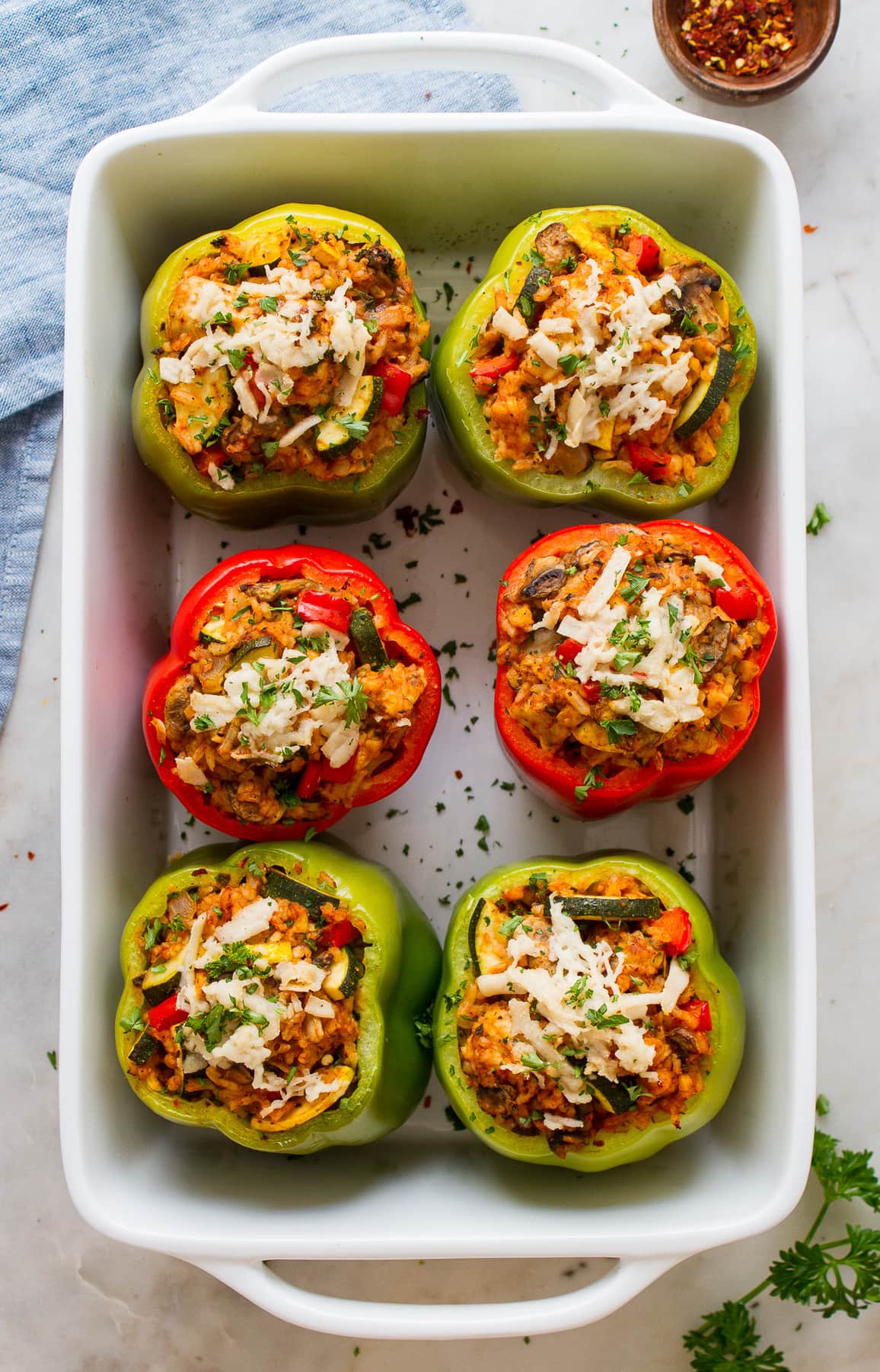 top down view of healthy vegan stuffed bell peppers freshly baked in a baking dish.