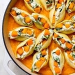 top down view of a casserole with freshly made butternut squash stuffed shells.