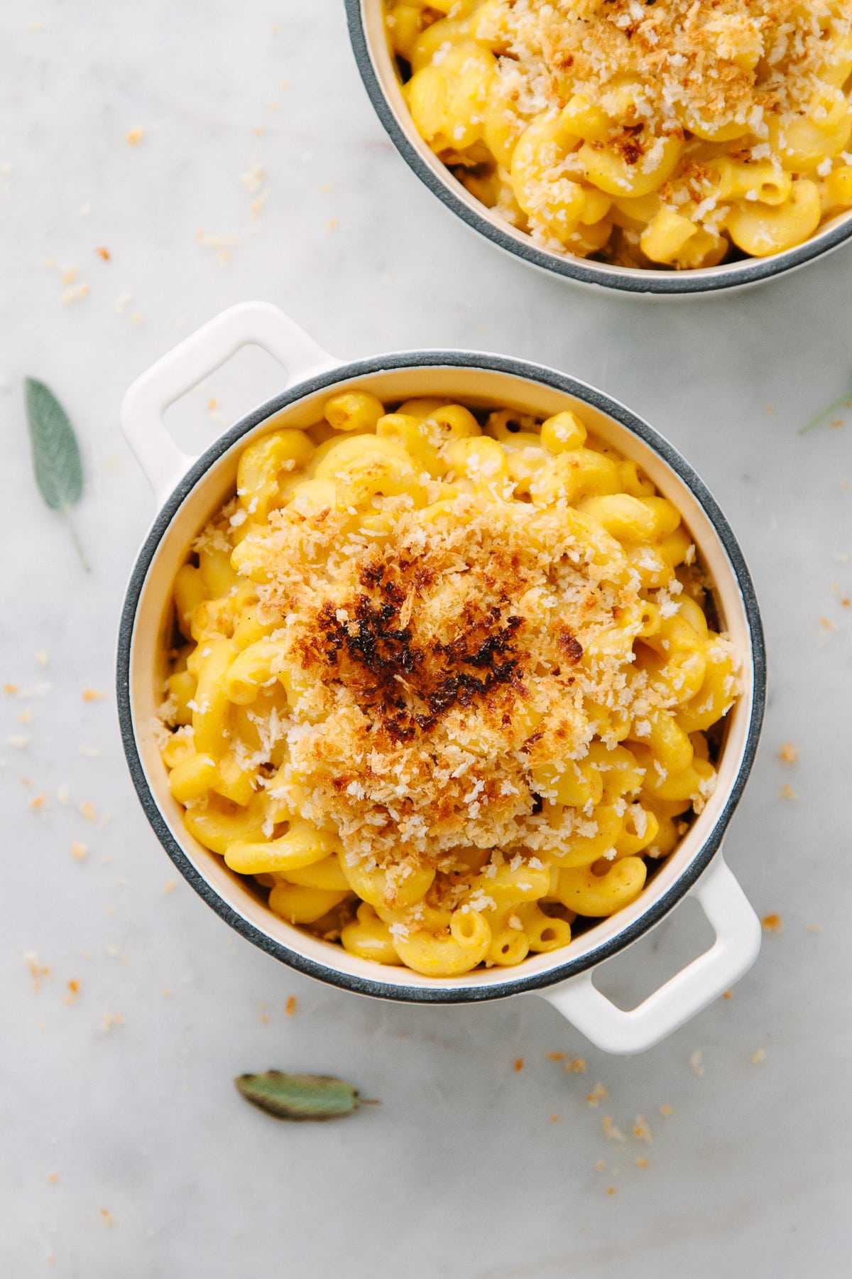 top down view of vegan baked butternut squash mac and cheese in a mini casserole.