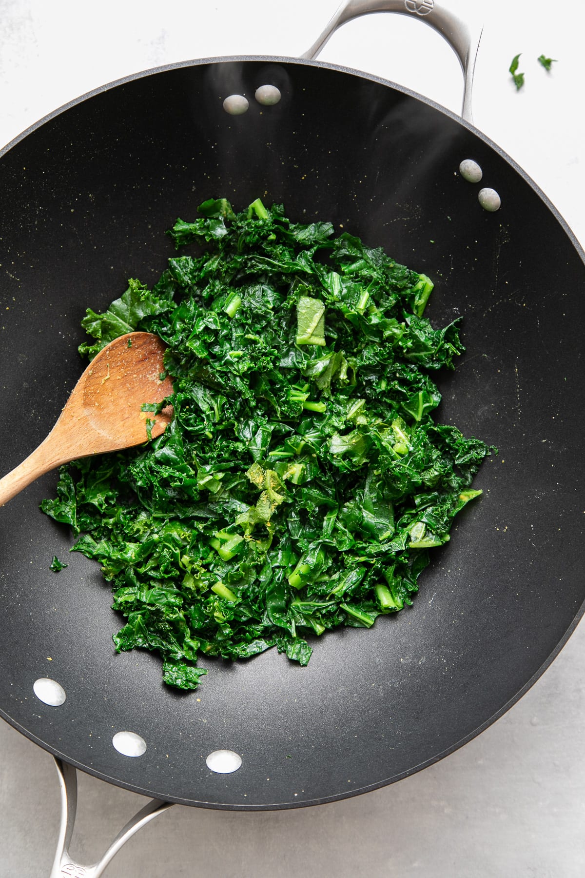 top down view of finished sauteed kale in a wok.