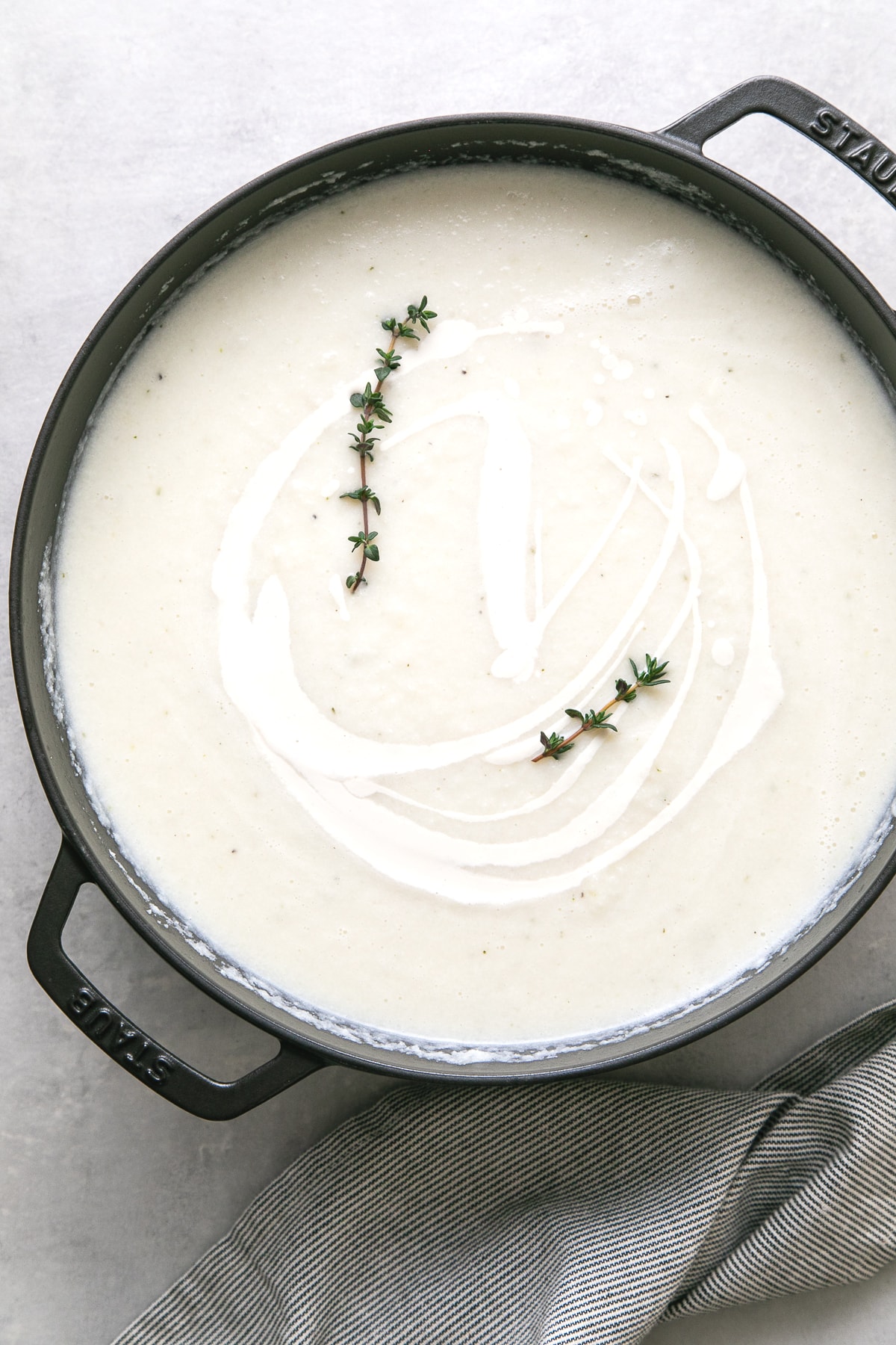 top down view of a freshly made pot of creamy vegan cauliflower soup.