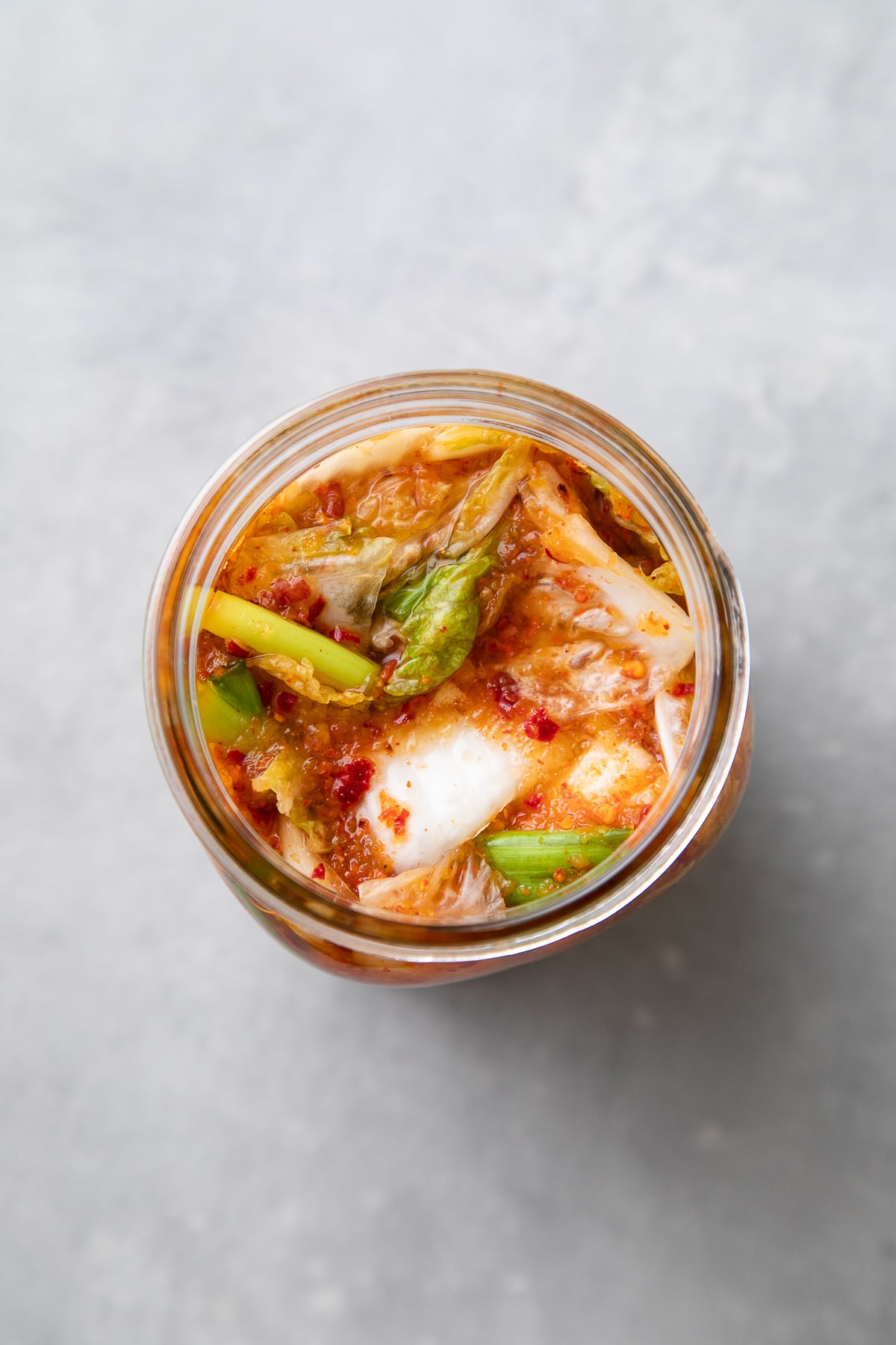 top down view of vegan kimchi before topping with lid and fermenting.