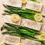 top down view of freshly baked lemon pepper tofu with asparagus on sheet pan.