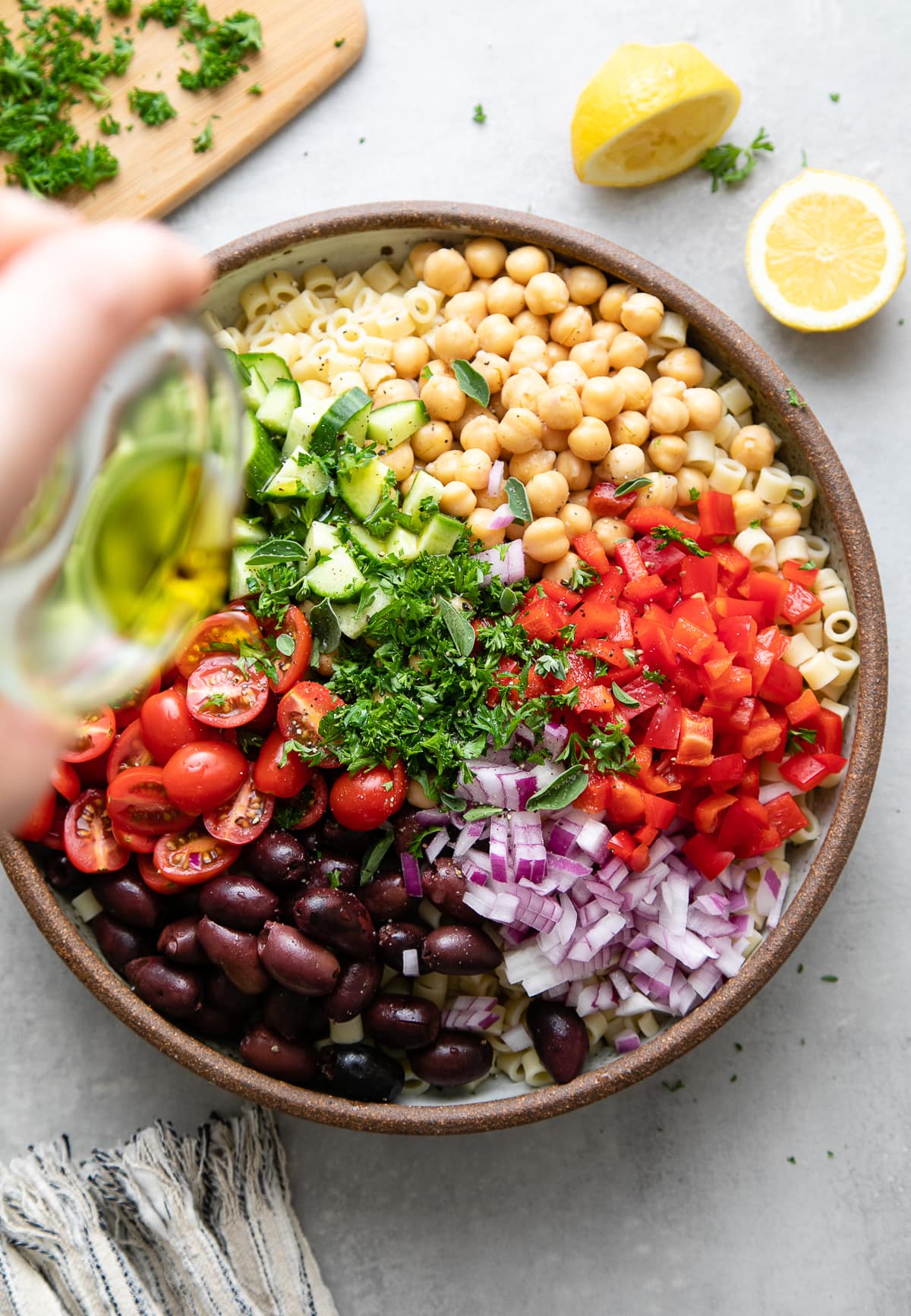 top down view of veggies, herbs and spices, added to pasta and ready to toss.