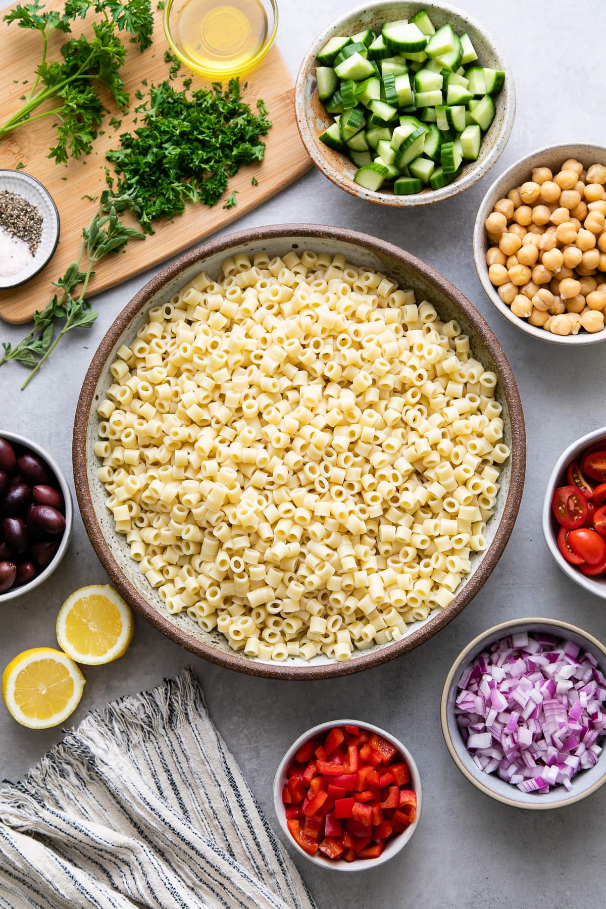 top down view of ingredients for Greek pasta salad prepped and ready to be combined.