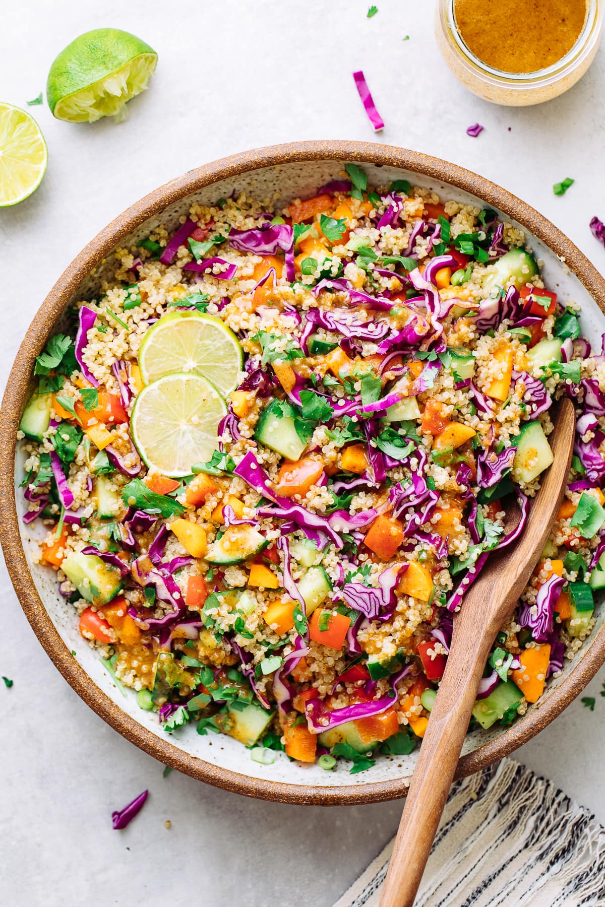 top down view of healthy Thai quinoa salad in a bowl with serving spoon.