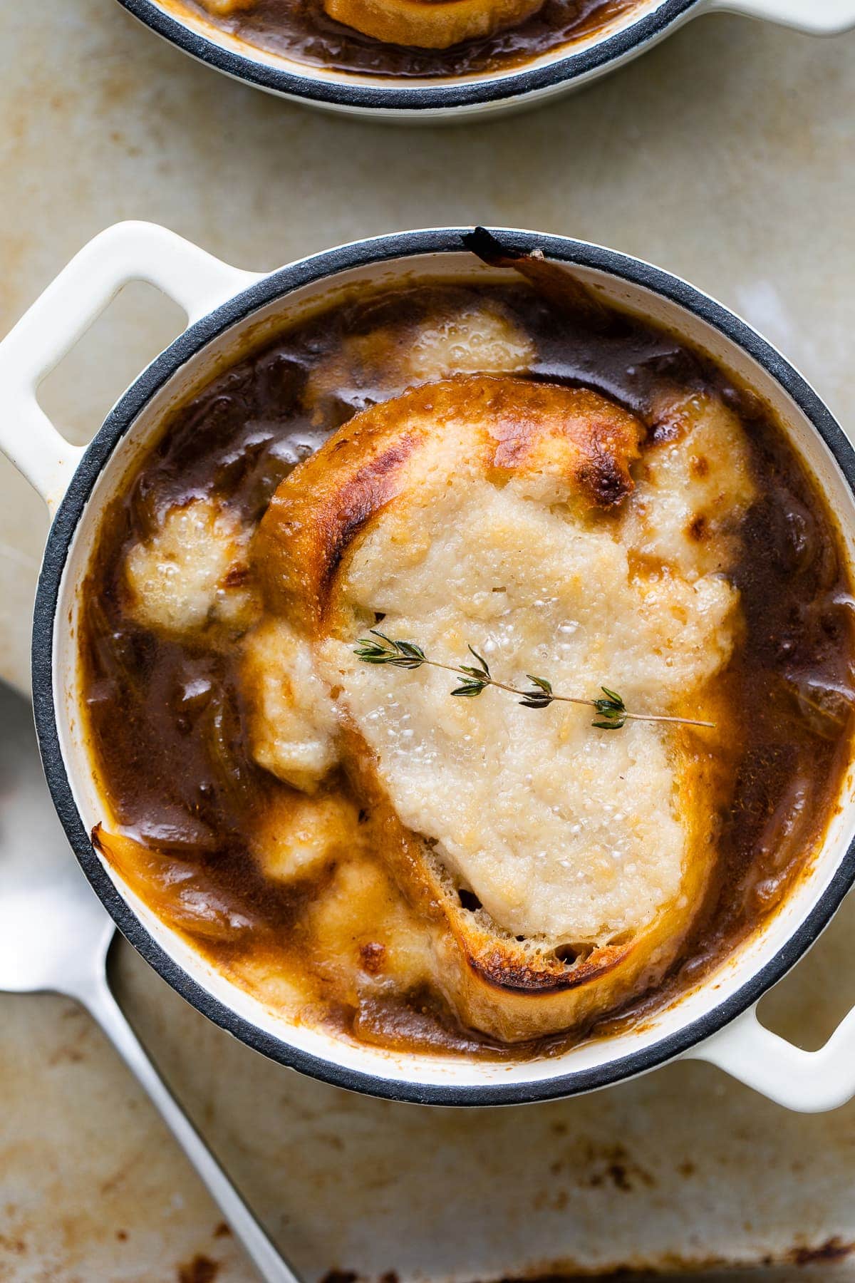 top down view of freshly made vegan french onion soup just pulled from the oven.