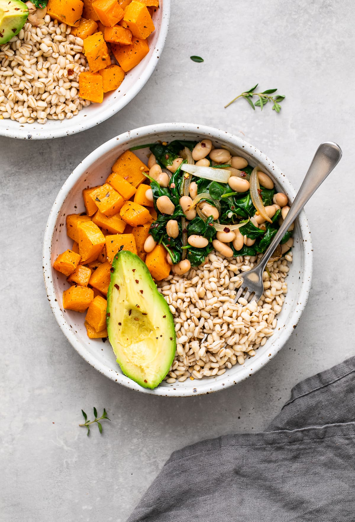 top down view of healthy barley bowl with items surrounding.