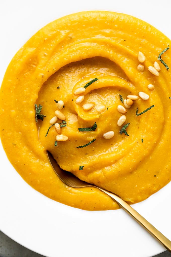 up close view of bowl with serving of healthy butternut squash red lentil soup.