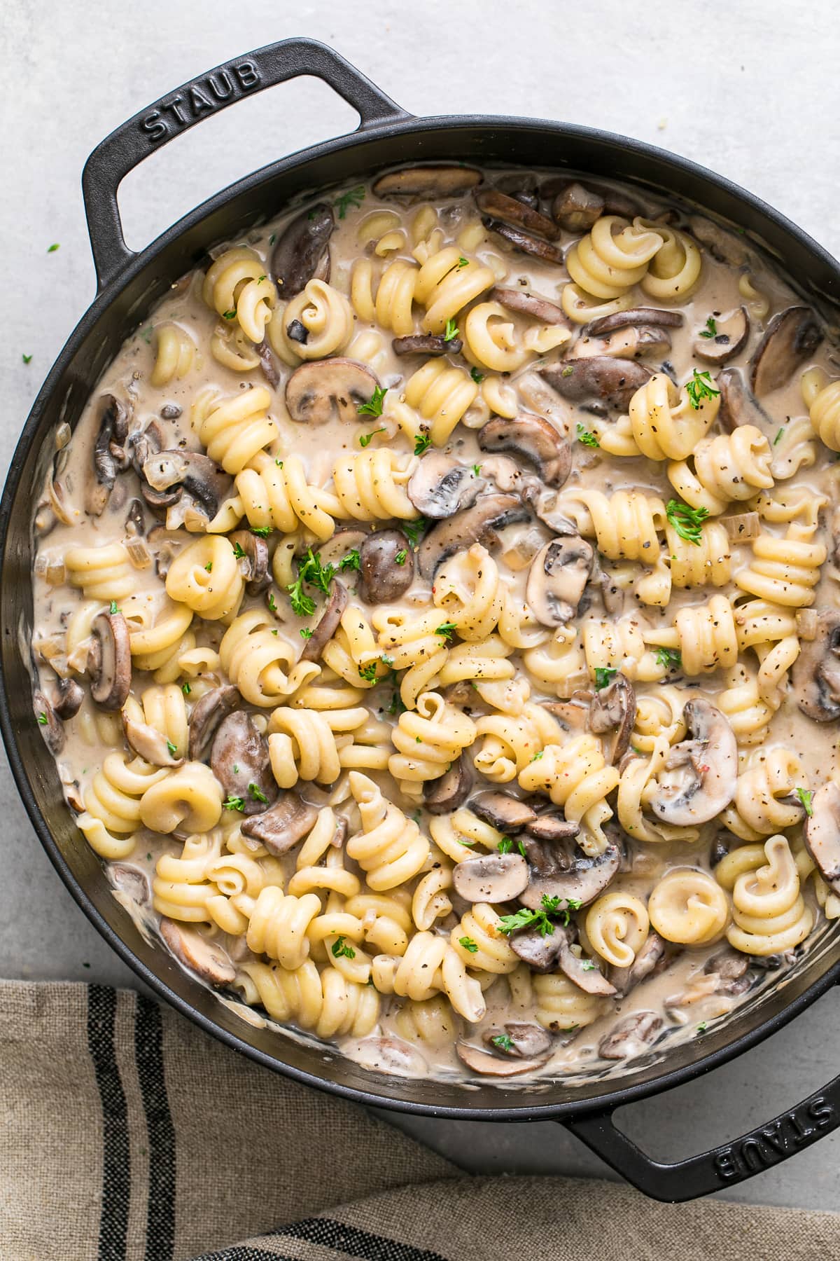 top down view of freshly made vegan mushroom stroganoff with pasta in a pot.