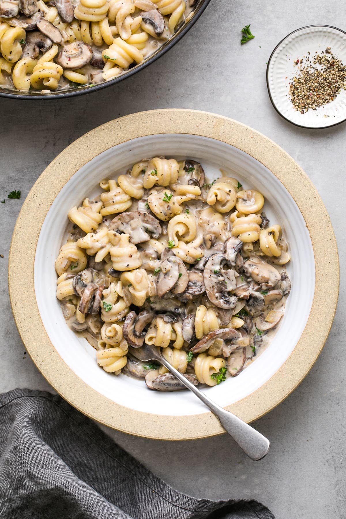 top down view of creamy vegan mushroom stroganoff in a bowl with spoon.