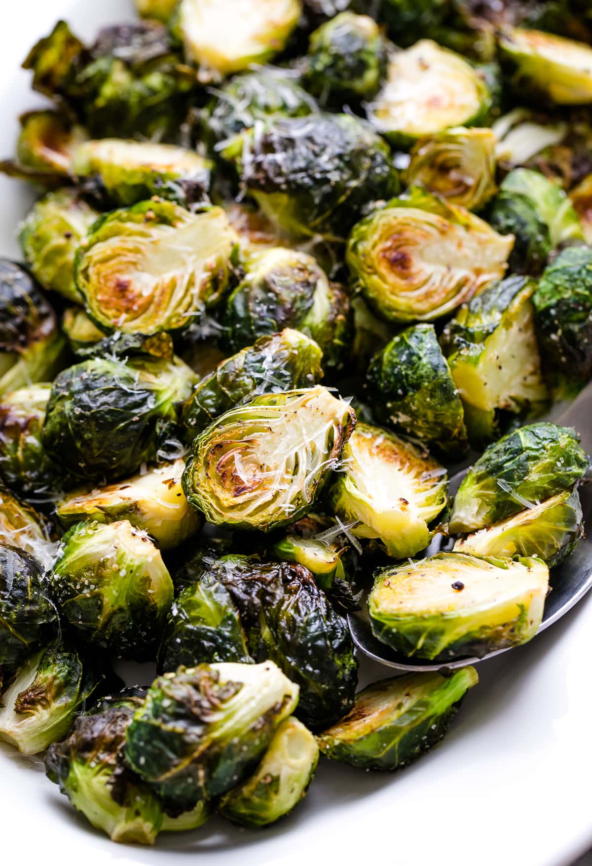 side angle view of serving platter with roasted brussels sprouts.