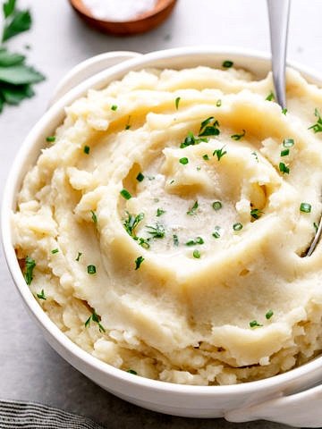 side angle view of vegan mashed potatoes in a serving bowl.