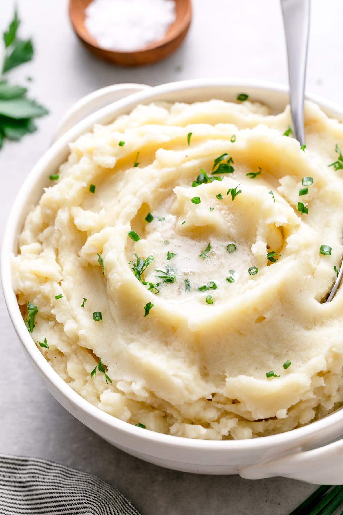 side angle view of vegan mashed potatoes in a serving bowl.