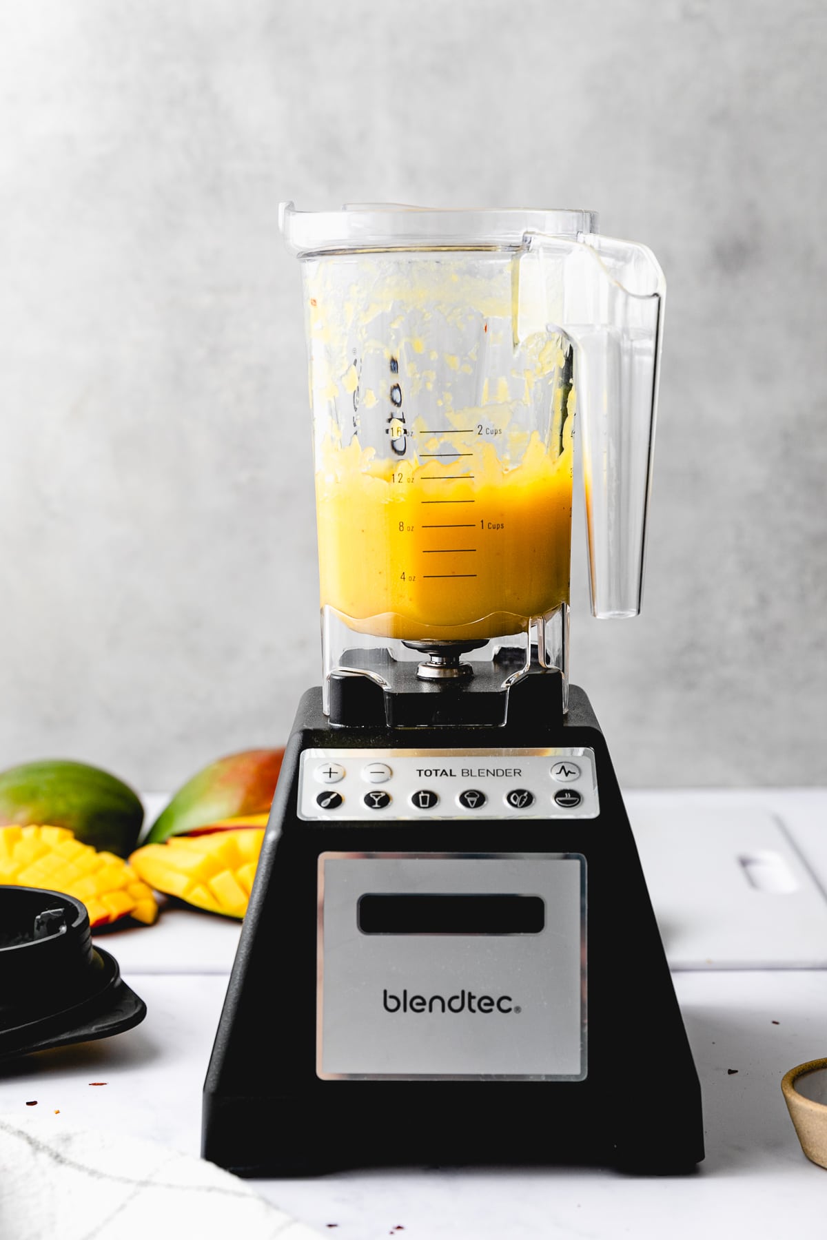 head on view of blender with fresh made mango dressing, showing how much it makes.