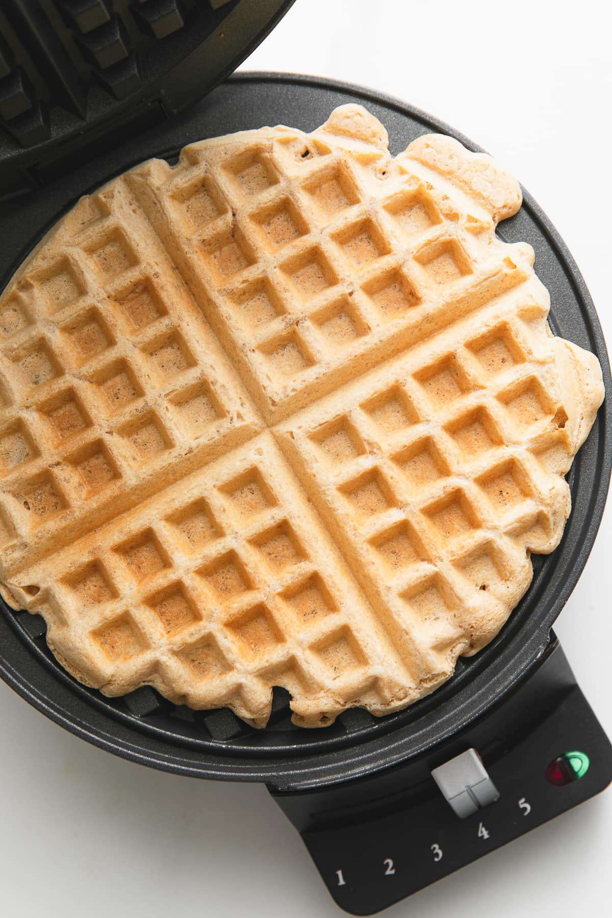 top down view of vegan waffle on waffle iron.