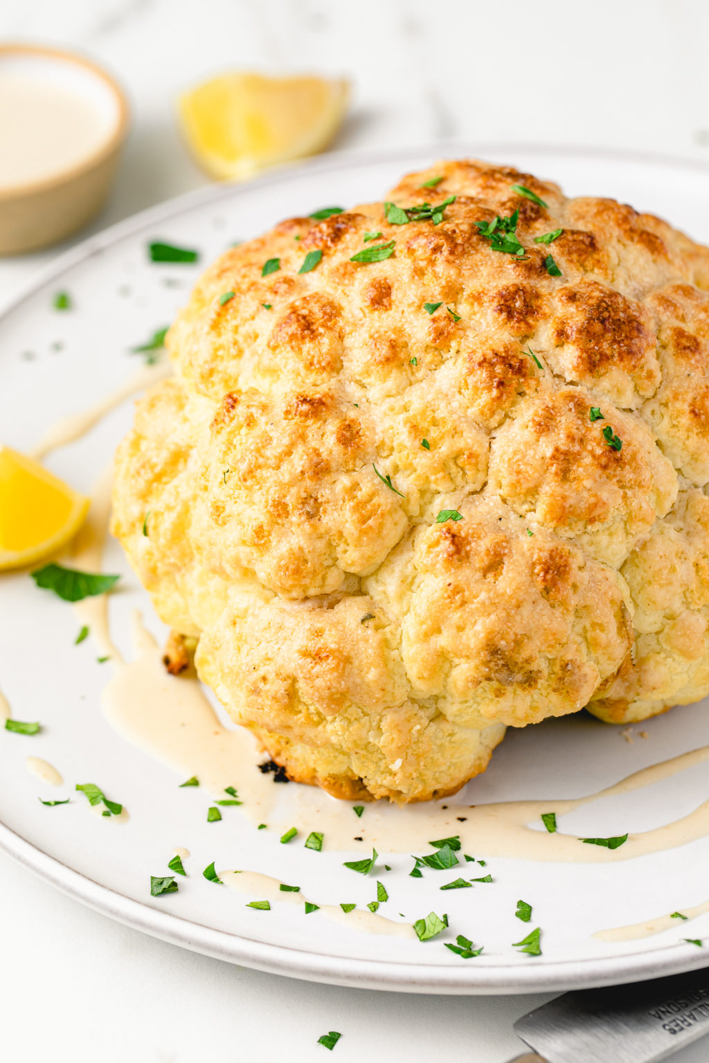 Whole Roasted Cauliflower w/ Tahini Sauce | The Simple Veganista